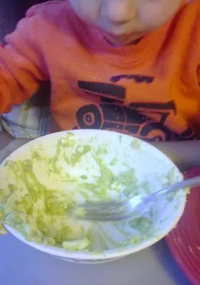 Little dude eating avocado egg salad out of bowl.