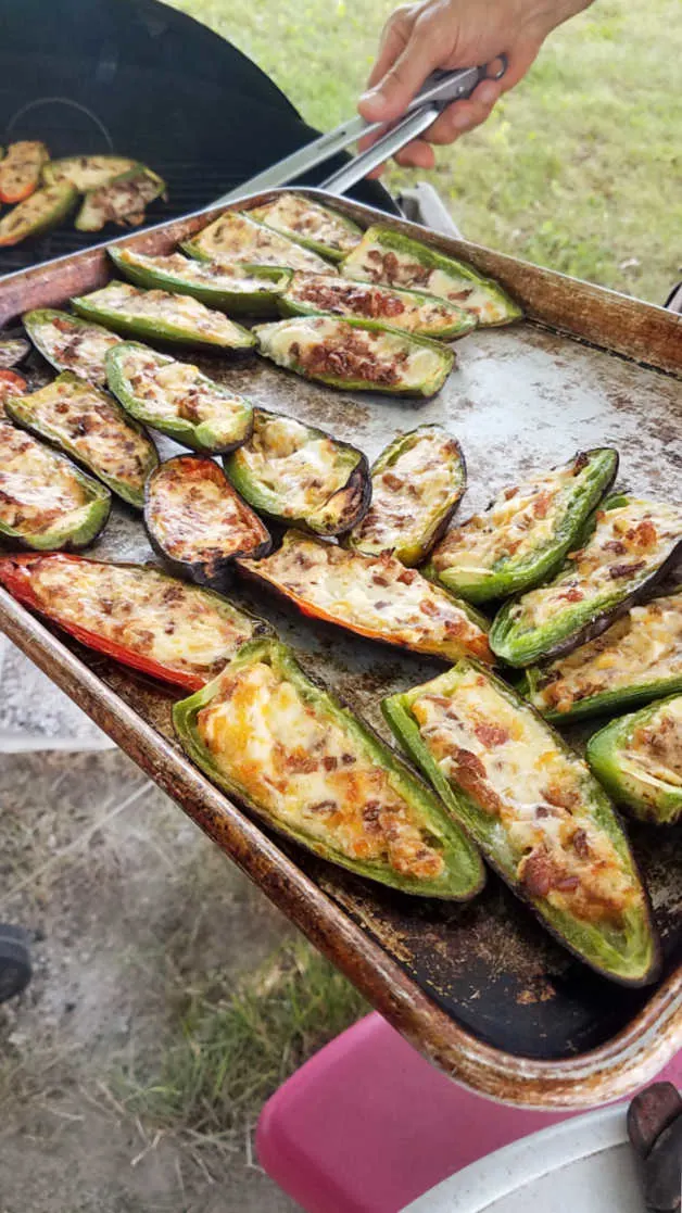 taking stuffed jalapenos off the grill