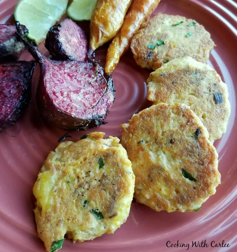 salmon patties with roasted beets and slices of lime