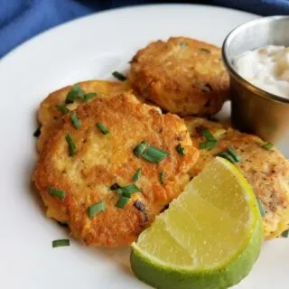 salmon and potato cakes with lime wedge and chives