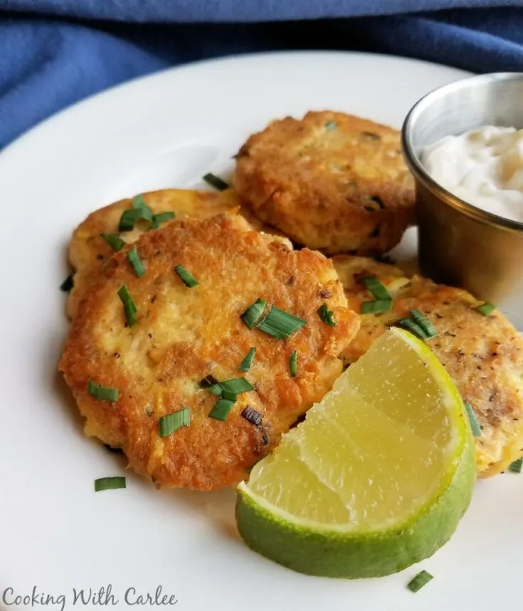 salmon and potato cakes with lime wedge and chives