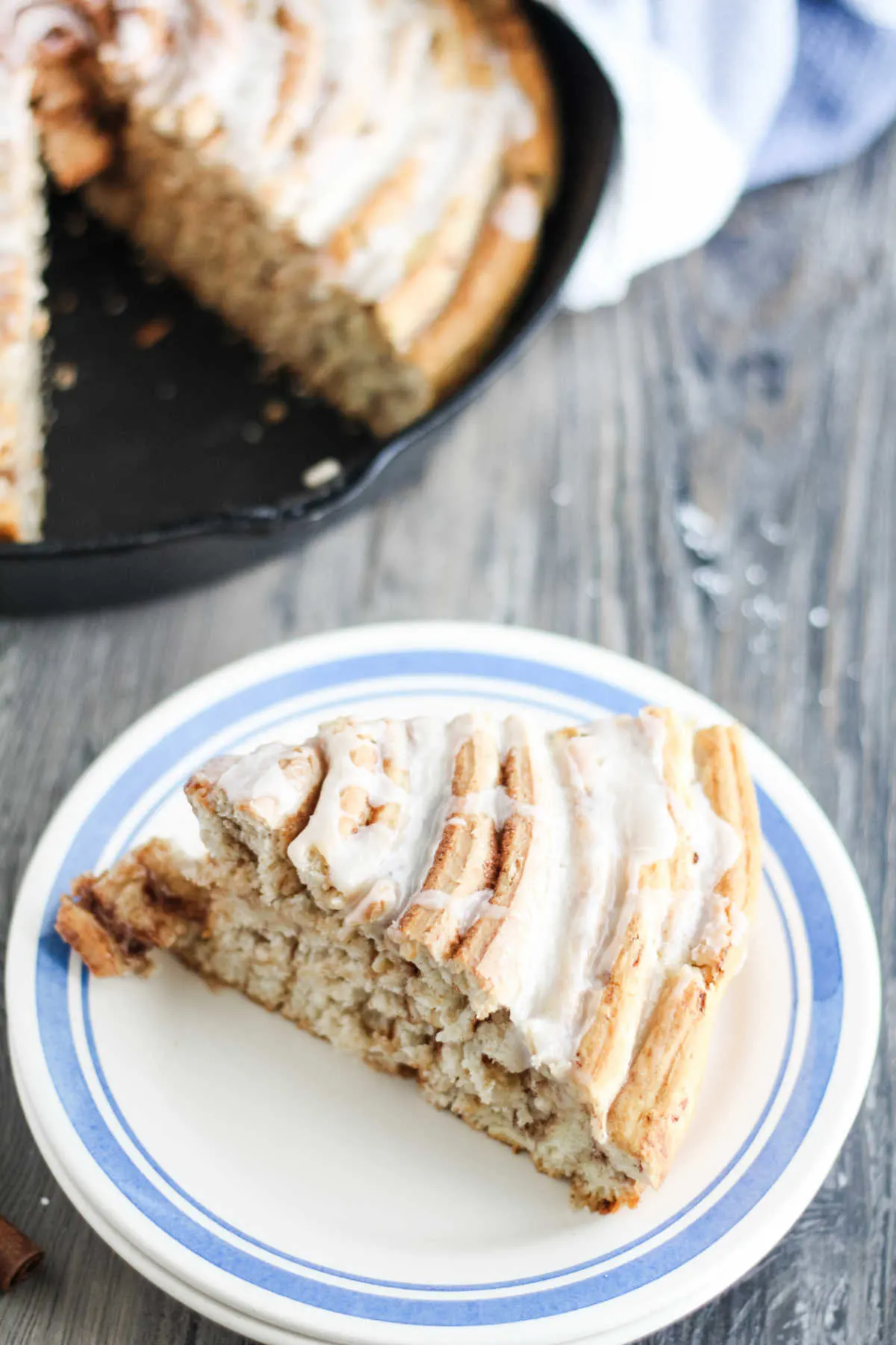 slice of giant cinnamon roll cake with lots of layers on plate ready to eat.