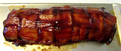 Cooked bacon explosion with shiny bbq sauce coating the exterior. 