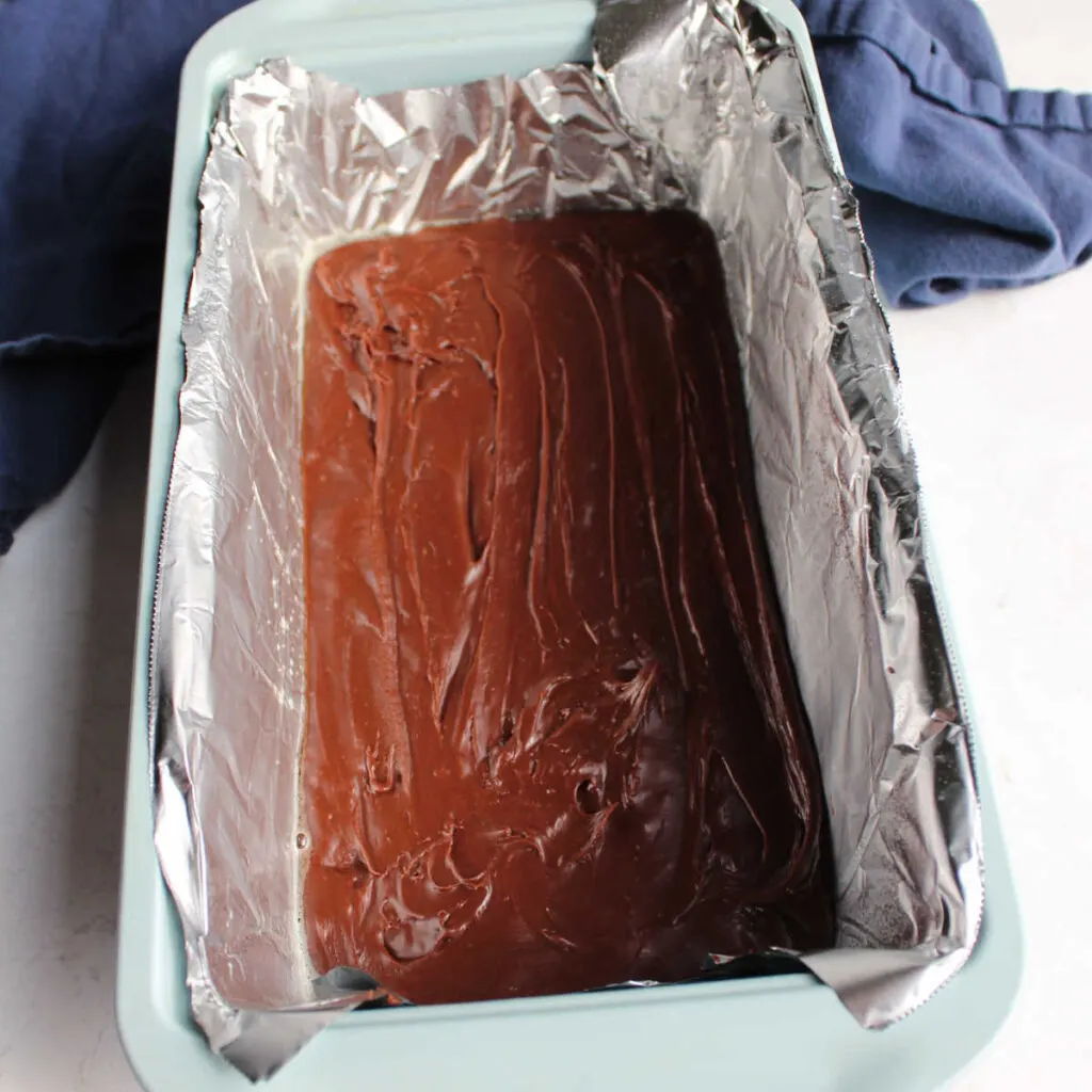 Chocolate fudge spread in foil lined loaf pan.