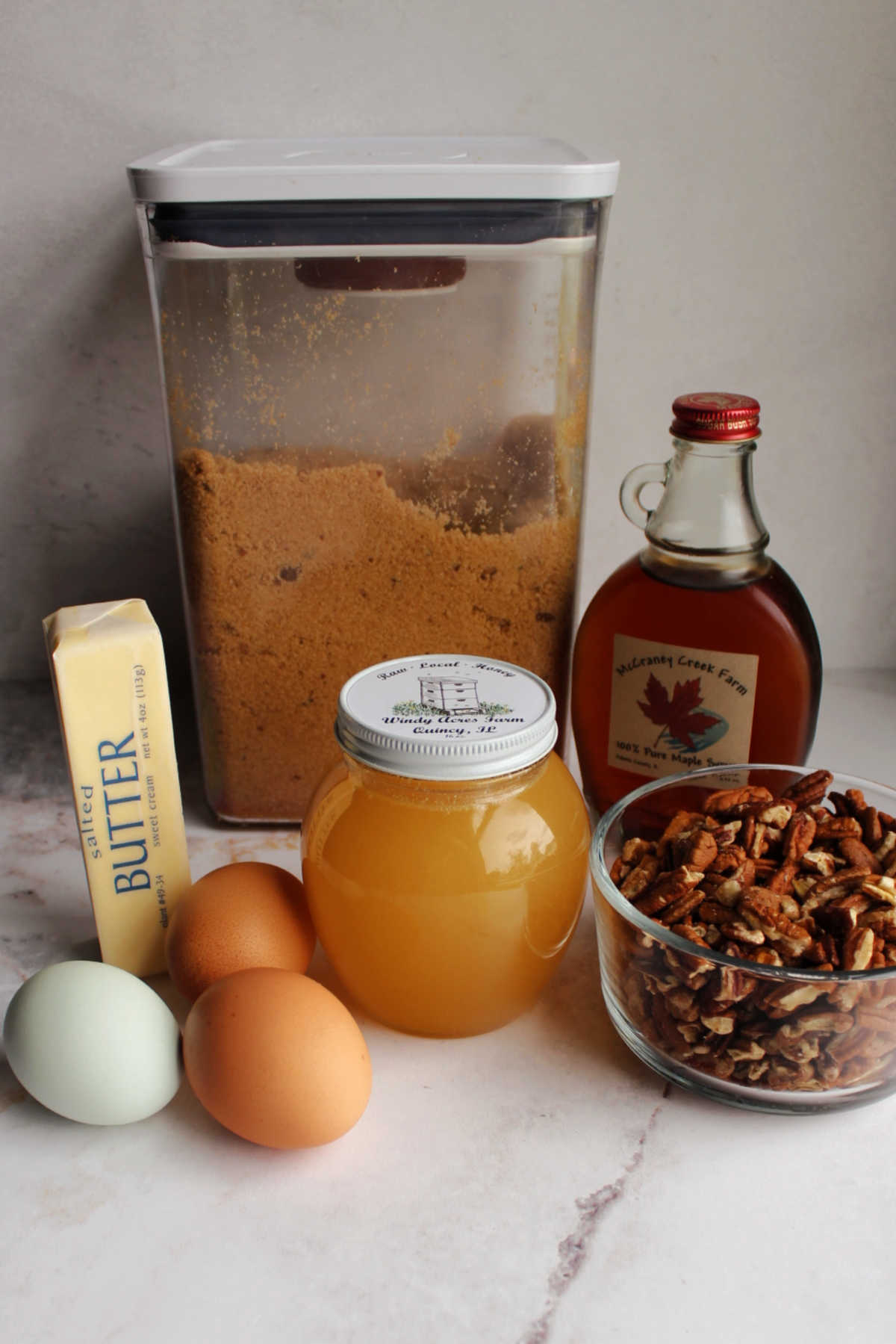 Ingredients for pecan pie made with maple syrup and honey.