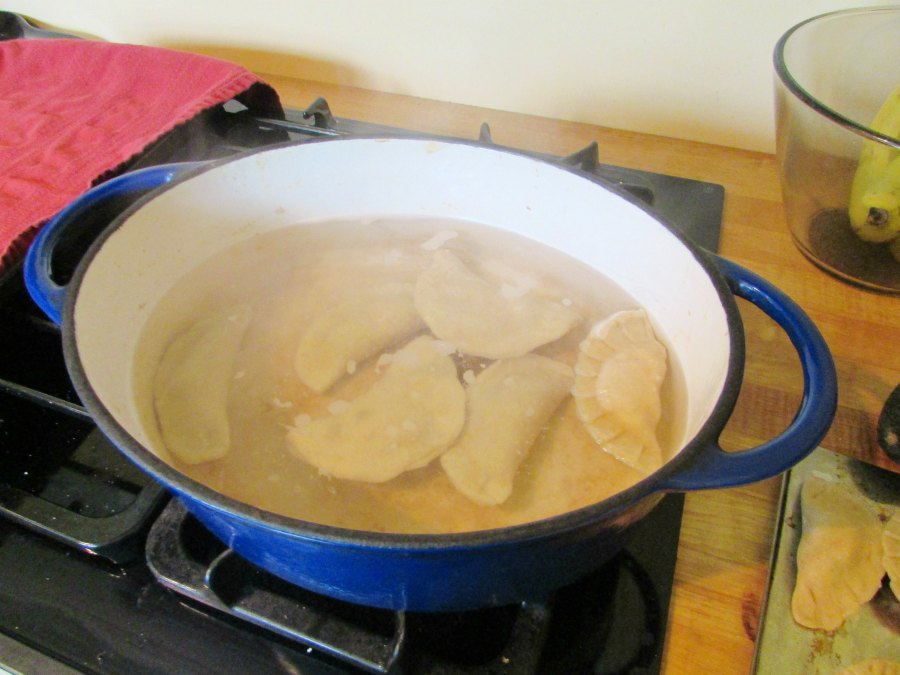 Pierogi boiling in enameled cast iron dutch oven.