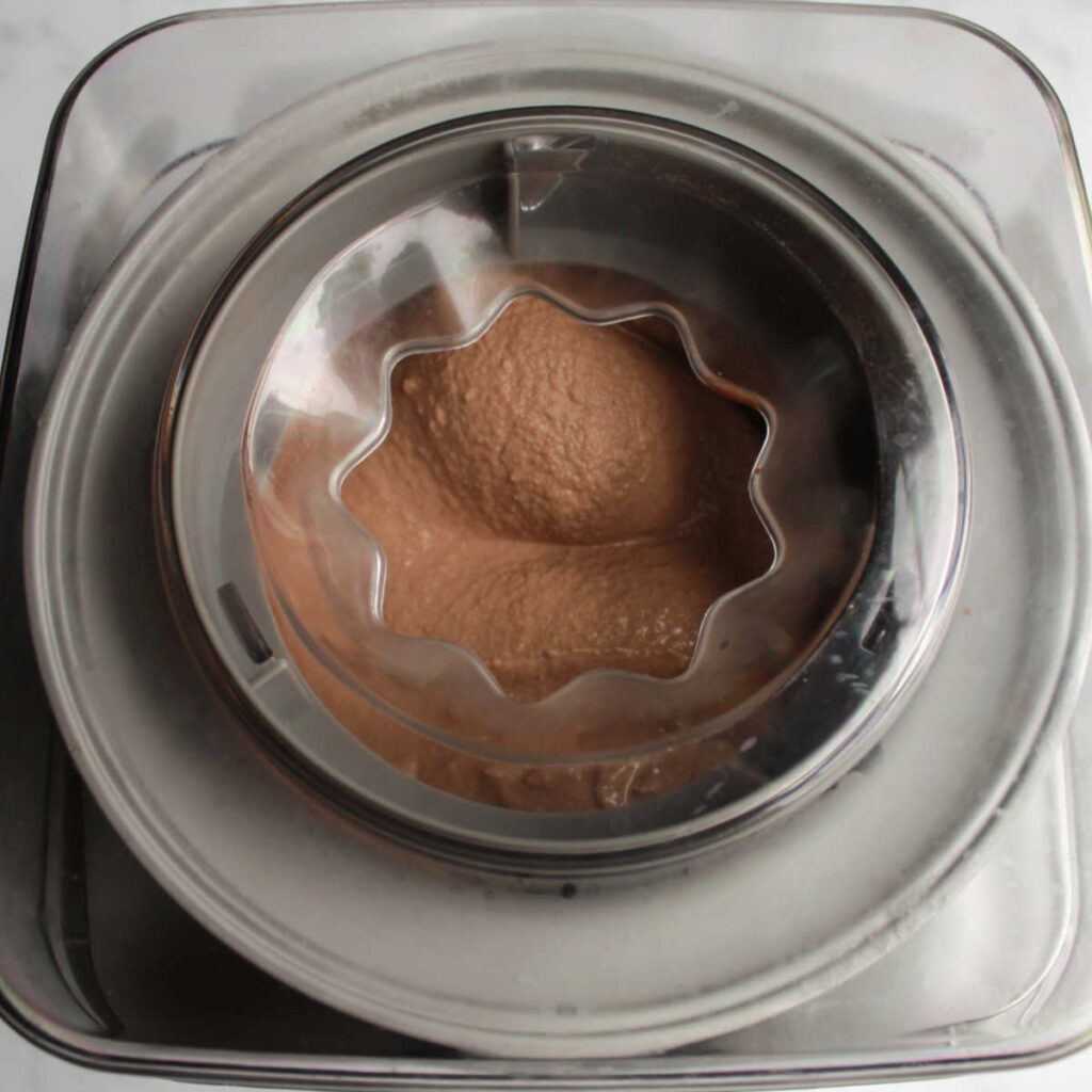 Chocolate brownie batter ice cream in machine.