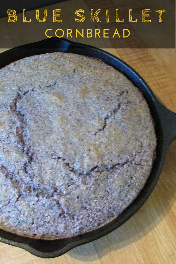 Blue hued cornbread in cast iron skillet with text across the top.