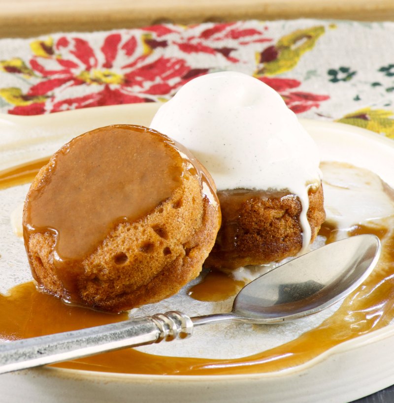 close up of two baby sweet potato cakes with vanilla ice cream and sticky caramel sauce.