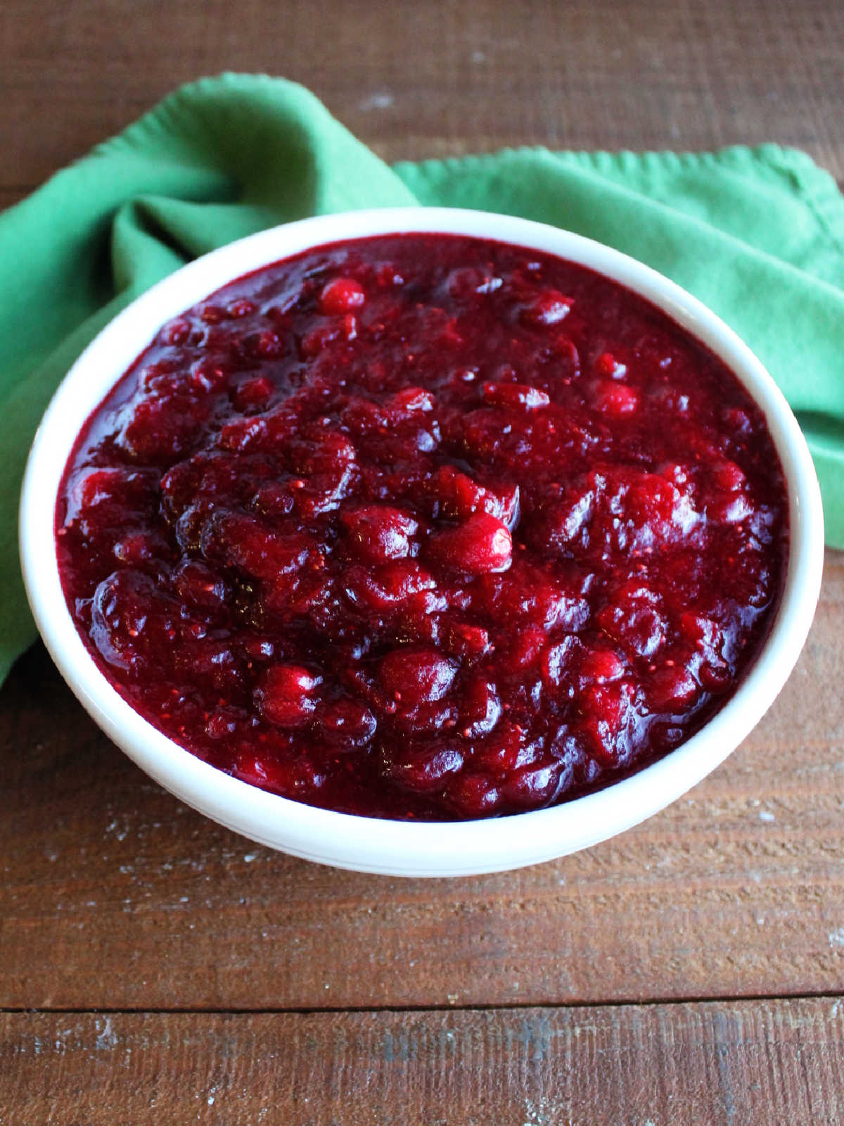 White serving bowl filled with chunky homemade cranberry sauce, ready to be served.
