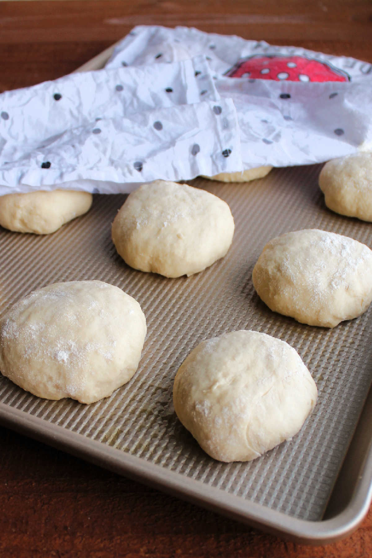 3 day roll dough formed into balls put on a greased baking sheet and covered with a towel to proof.