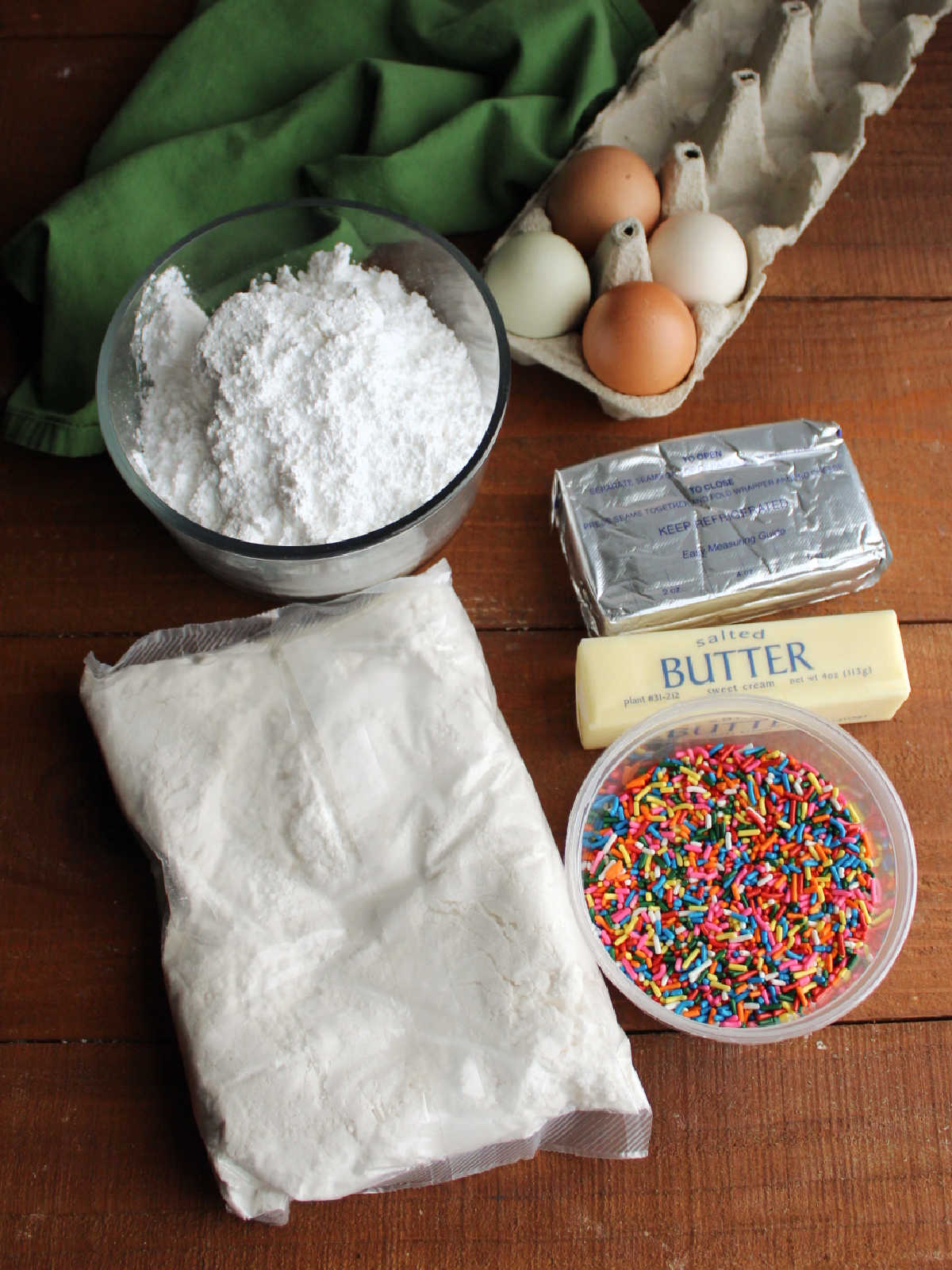 Ingredients including cake mix, sprinkles, butter, cream cheese, powdered sugar, and eggs.
