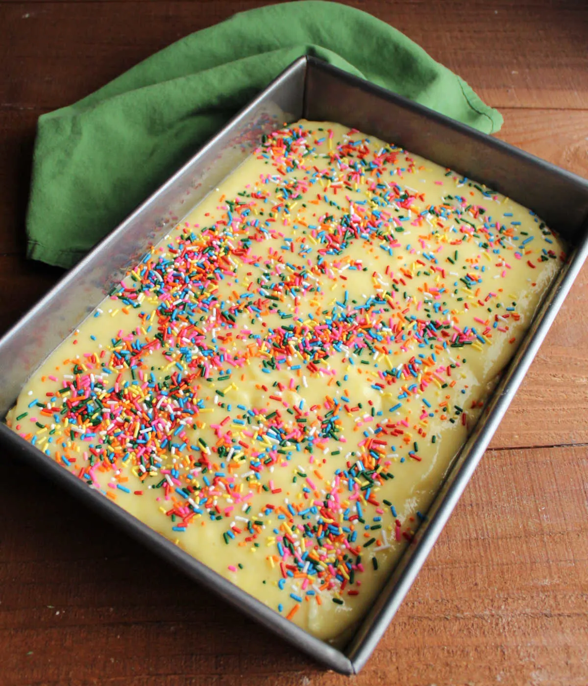 Funfetti chess bars topped with sprinkles, ready to go in the oven. 