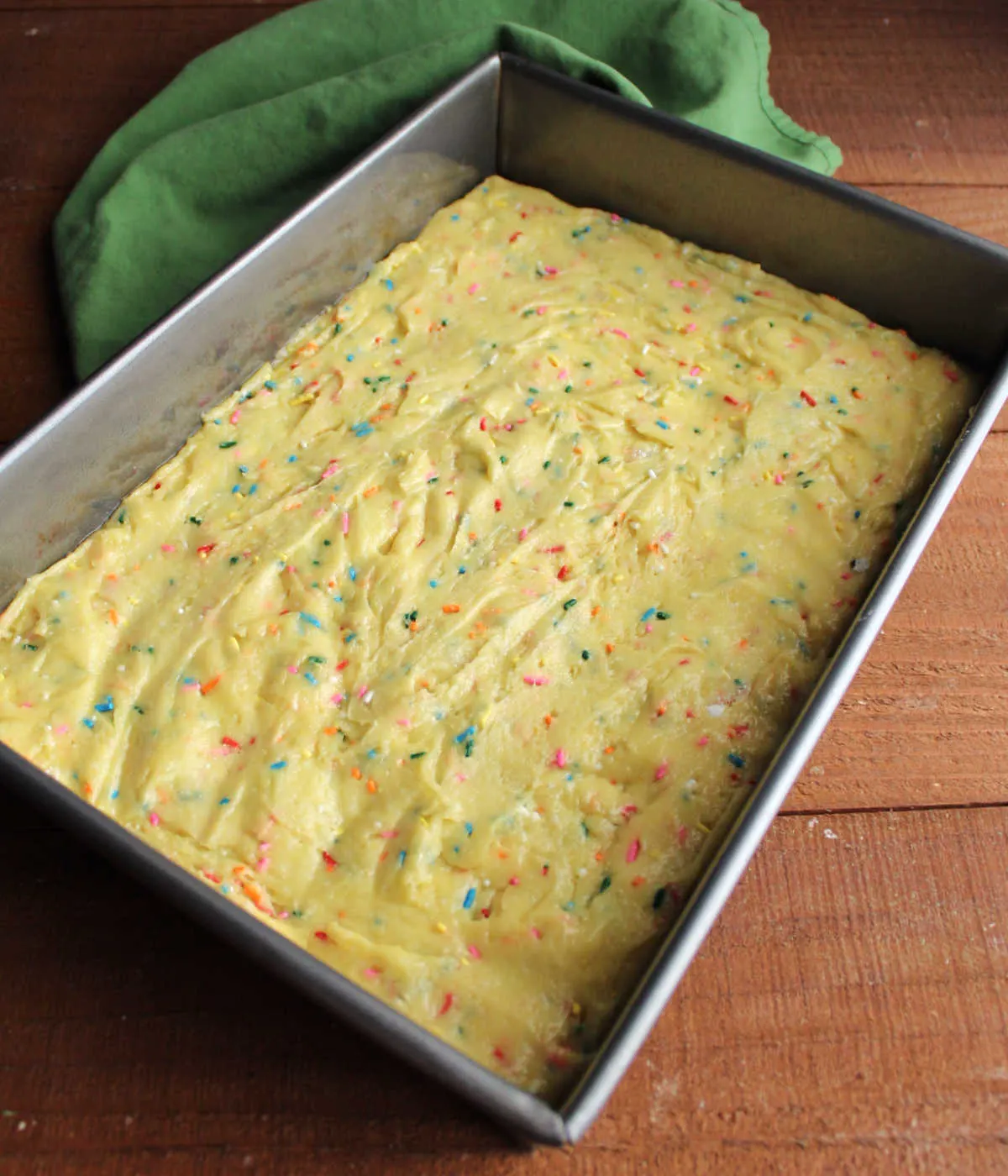 Cake batter dough spread in greased 9x13-inch pan.