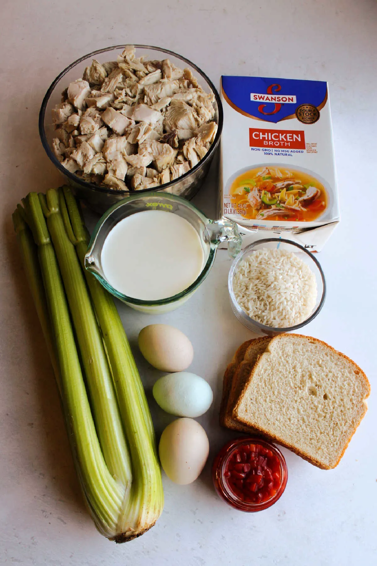 Ingredients: turkey, rice, milk, eggs, celery, bread and stock ready to be made into casserole.