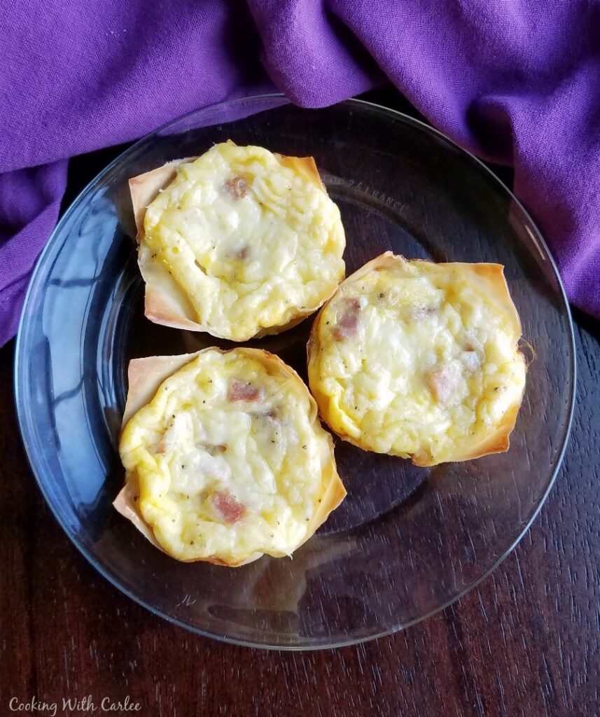 3 mini ham and cheese quiche on plate, ready to eat.