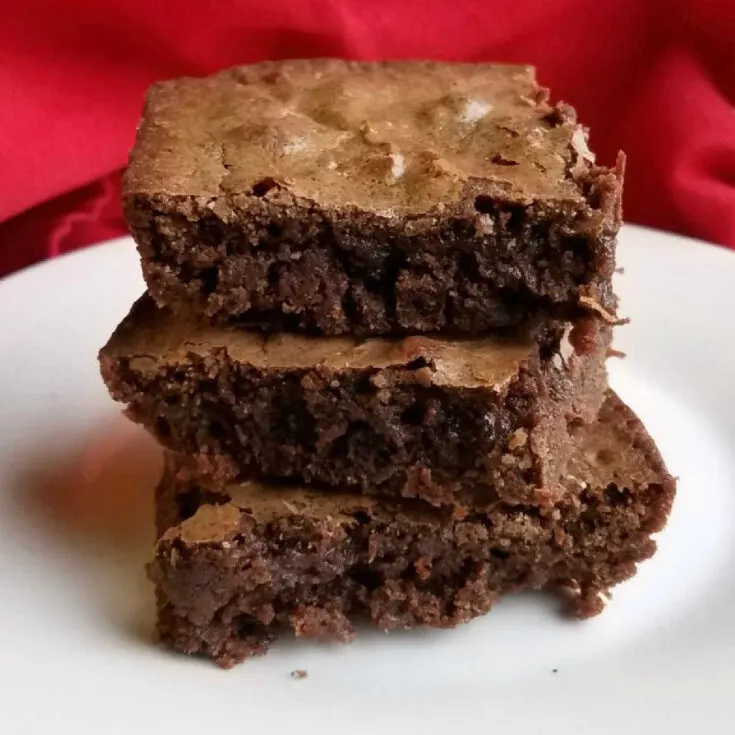 stack of fudgy brownies with crackly tops.