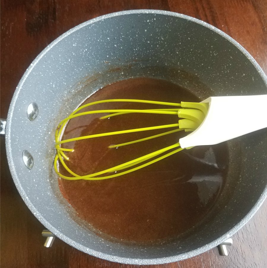 saucepan with brownie batter and whisk.