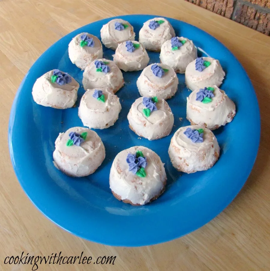 large blue platter filled with frosted angel food cupcakes, ready to serve and eat.