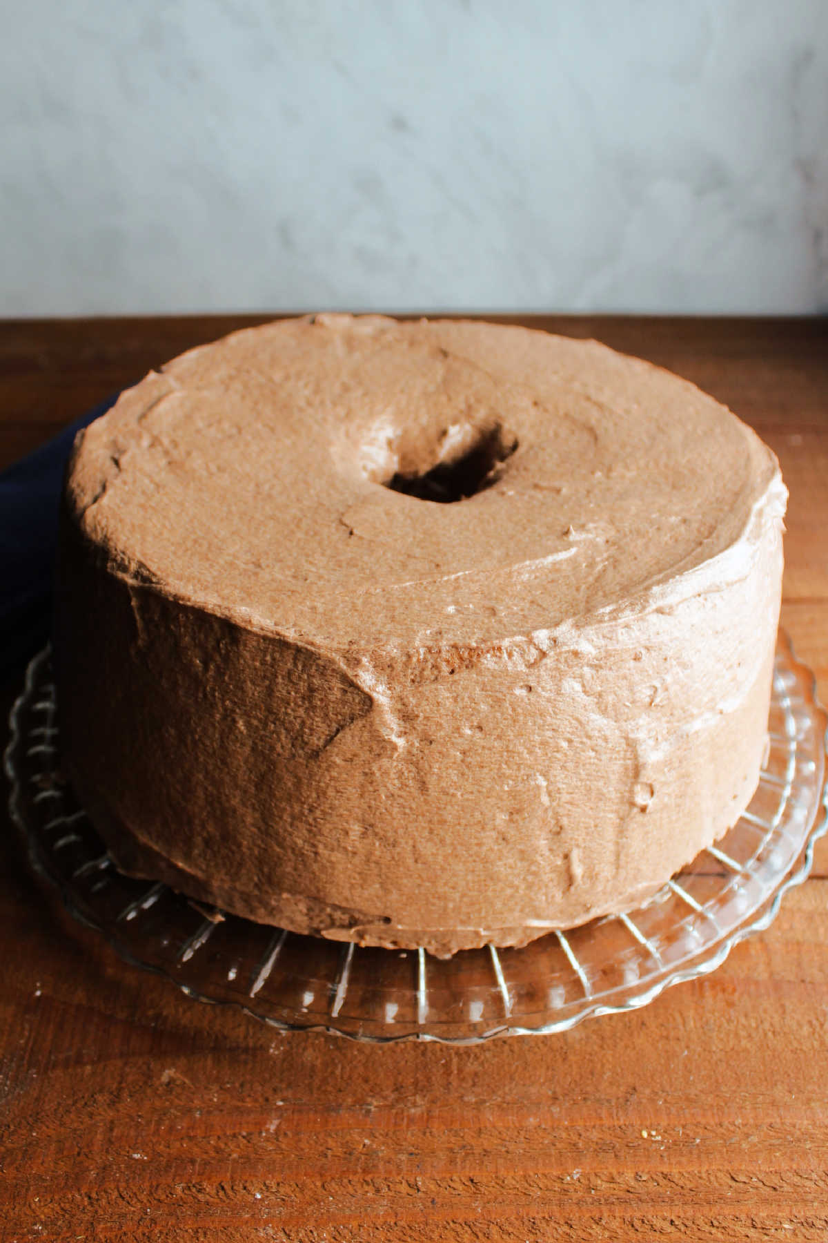 Coffee angel food cake coated in layer of fluffy mocha frosting.