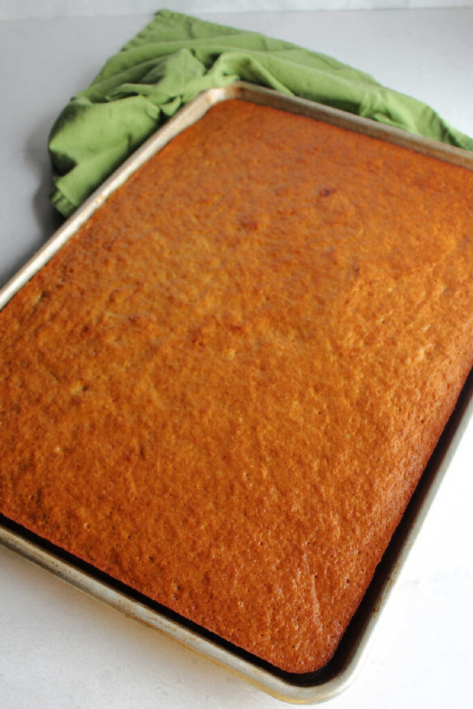 Half sheet pan filled with banana cake fresh from the oven.