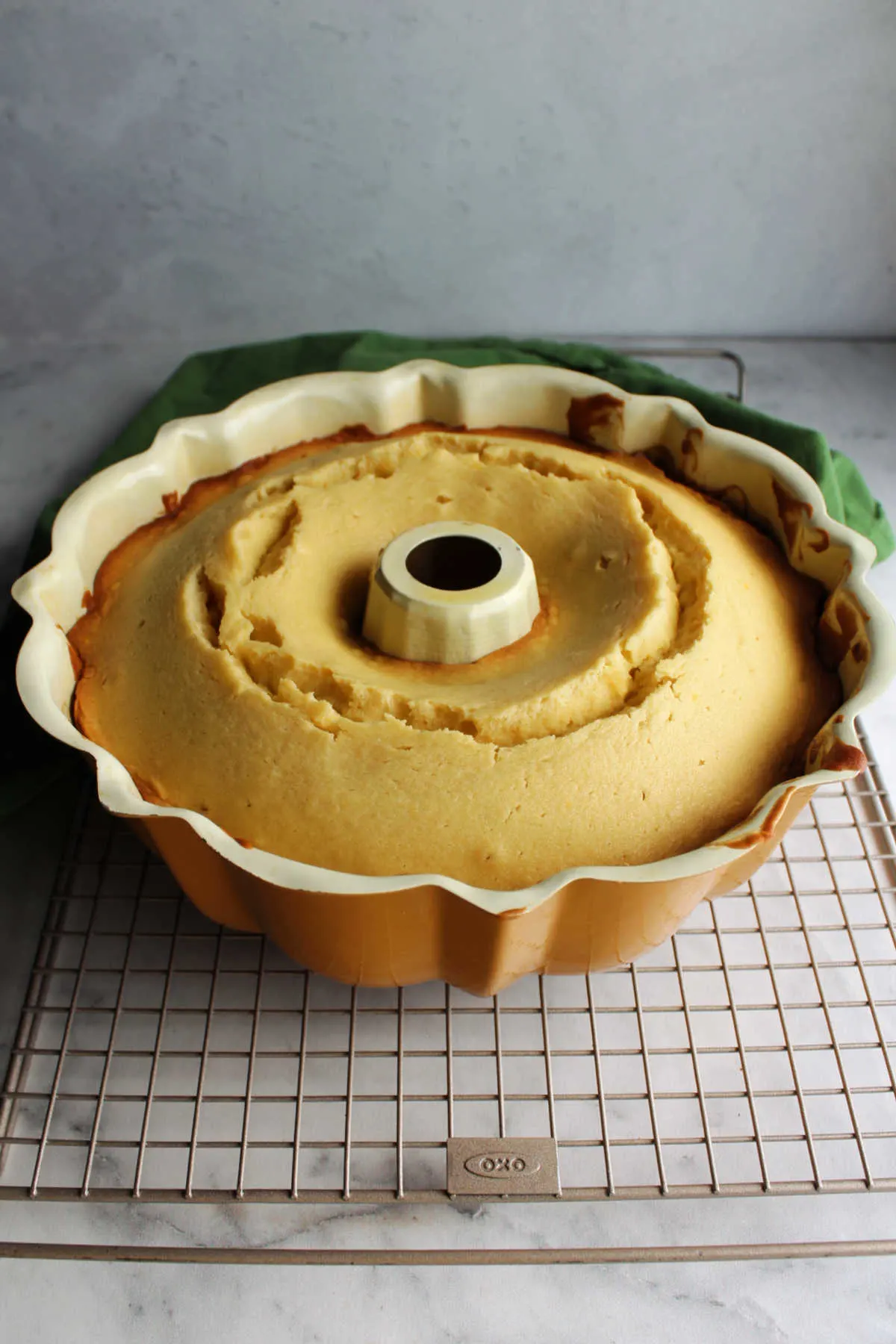 Honey lemon bundt cake fresh from the oven cooling in its pan. 