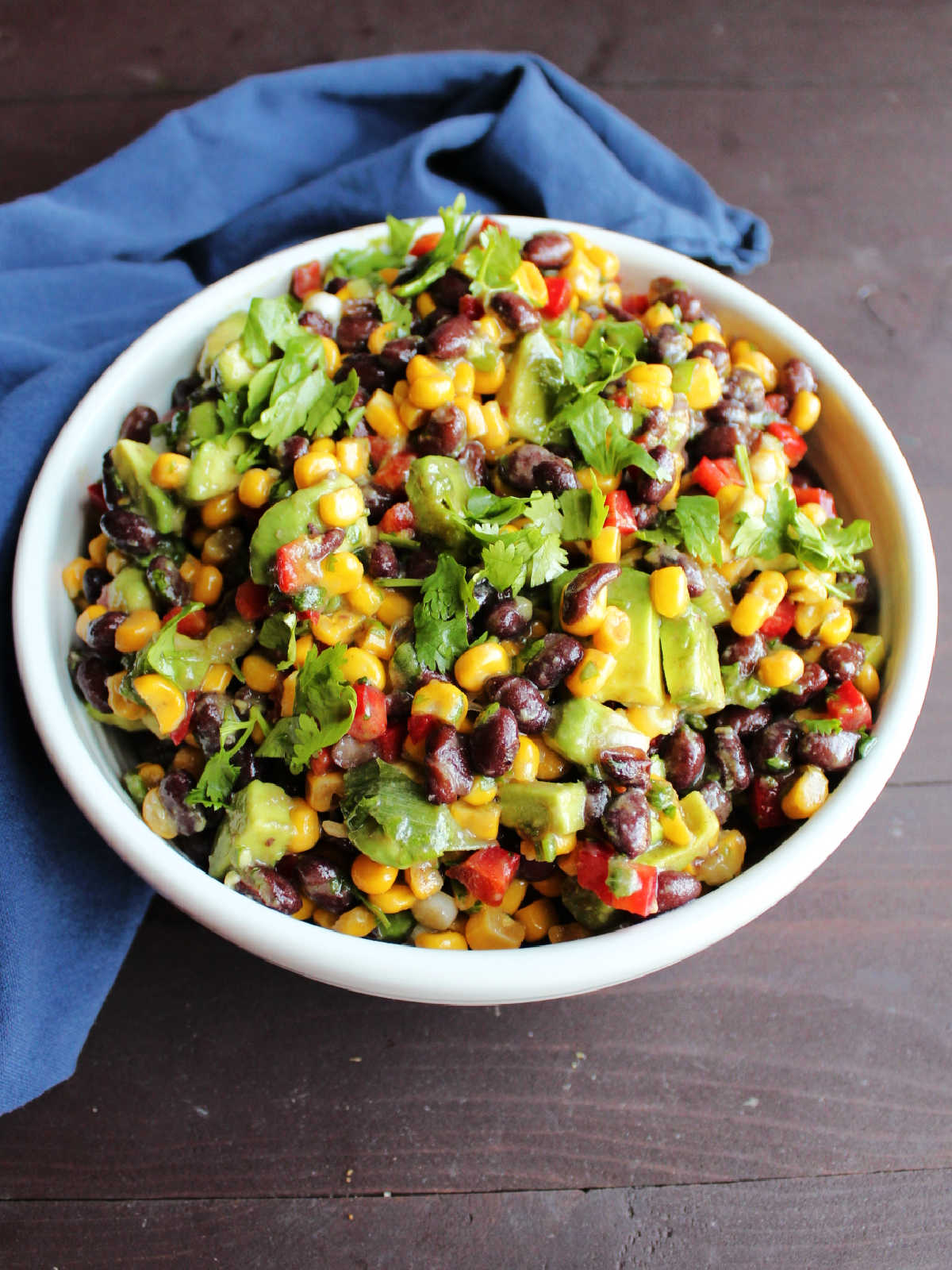 bowl of black bean salad topped with chopped cilantro, ready to serve.