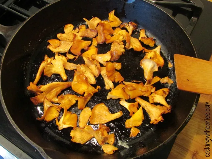 Cooking chanterelle mushrooms in skillet.