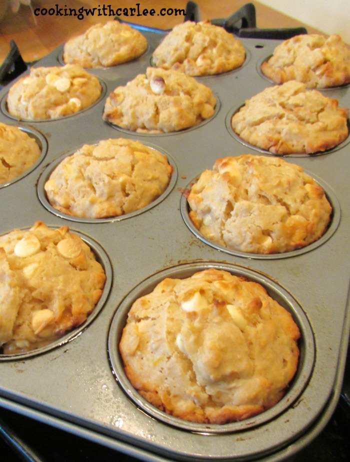 Muffin tin filled with orange creamsicle sourdough muffins fresh from the oven.