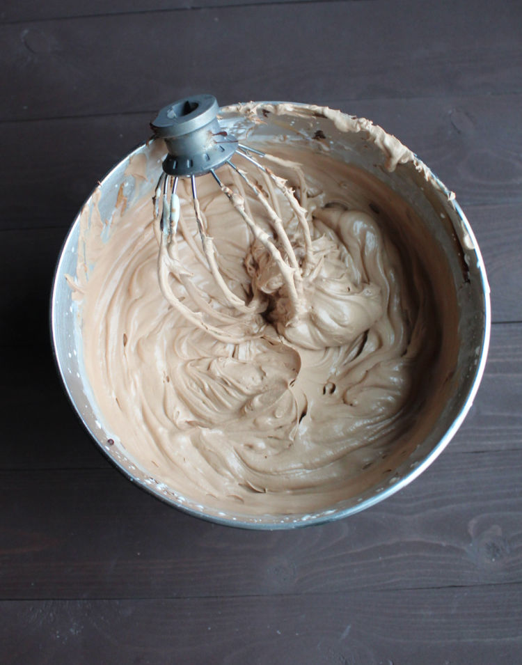 mixer bowl filled with fluffy mocha cheesecake filling and balloon whisk