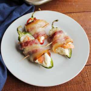 Bacon and shrimp jalapeno poppers on plate ready to eat.