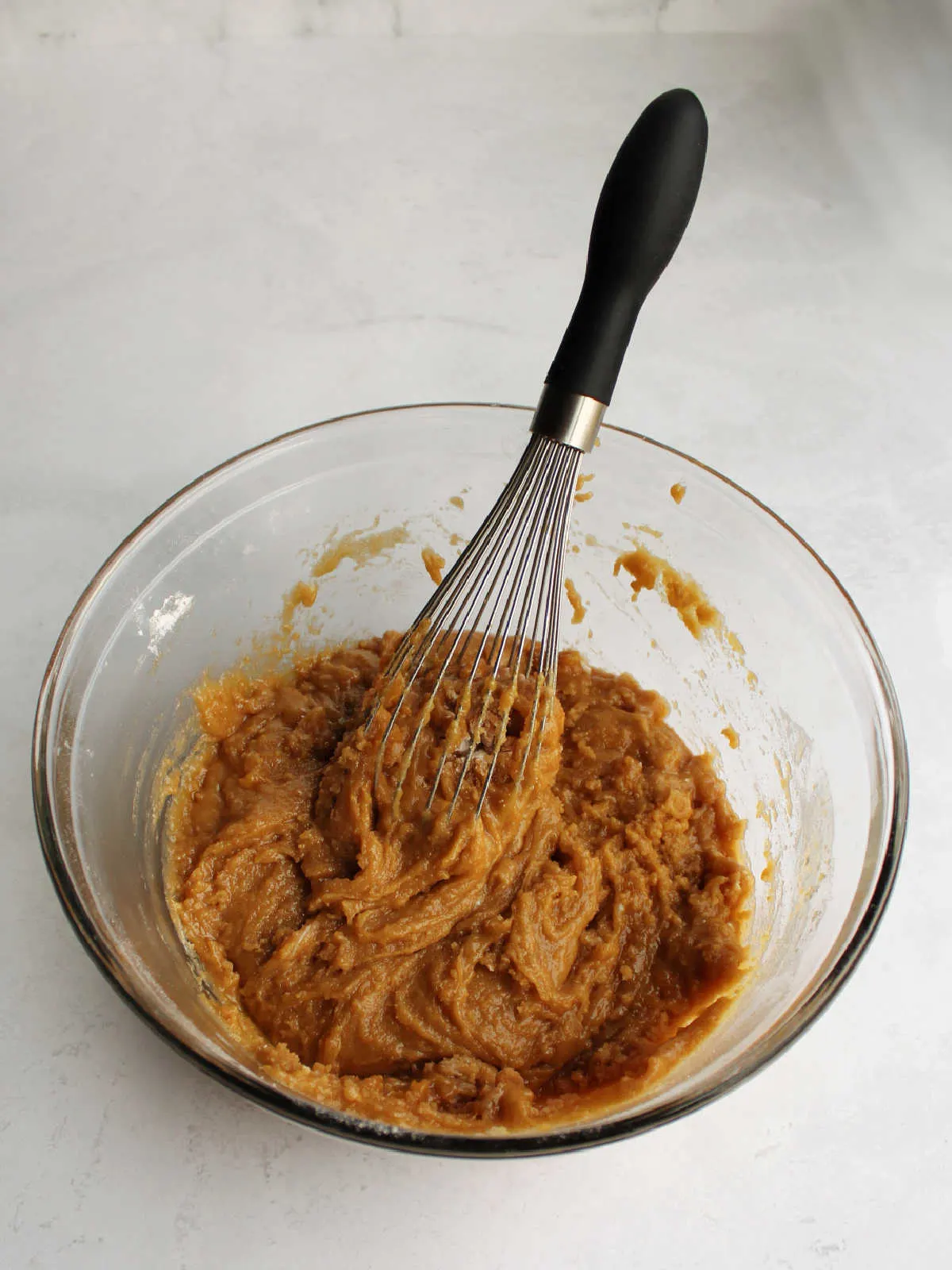 mixing bowl filled with blondie batter and whisk.