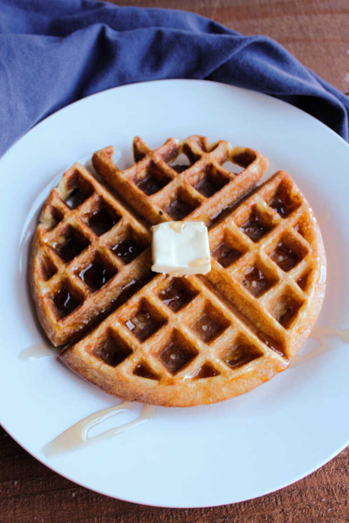 sourdough waffle with butter and maple syrup