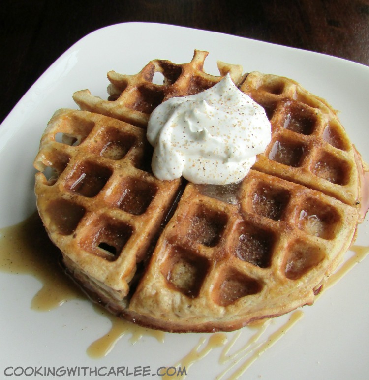 apple cider waffle drizzled with cider caramel and topped with a dollop of whipped cream.