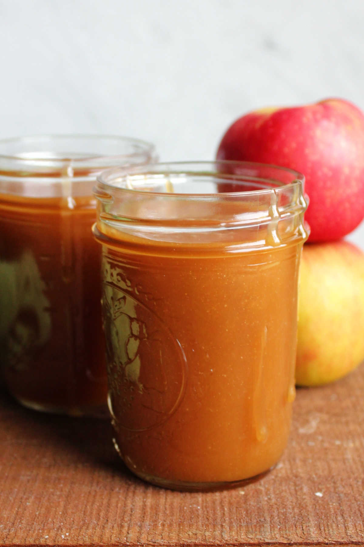 Jars of homemade apple cider caramel sauce.