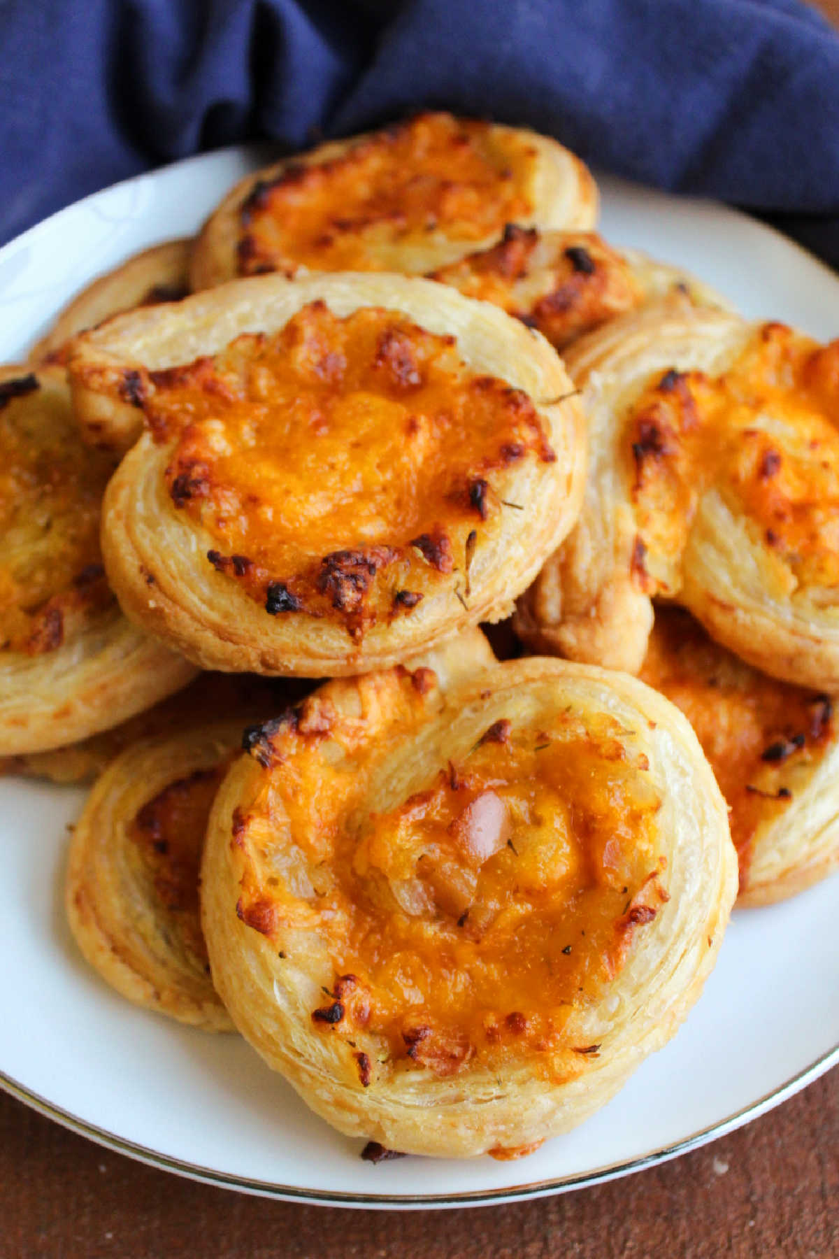 Plate of apple cheddar pinwheel appetizers ready to eat. 