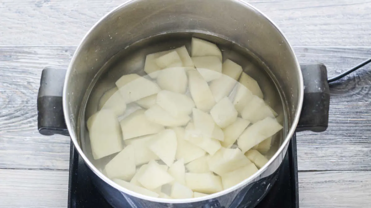 pan of potatoes boiling for potato dough.