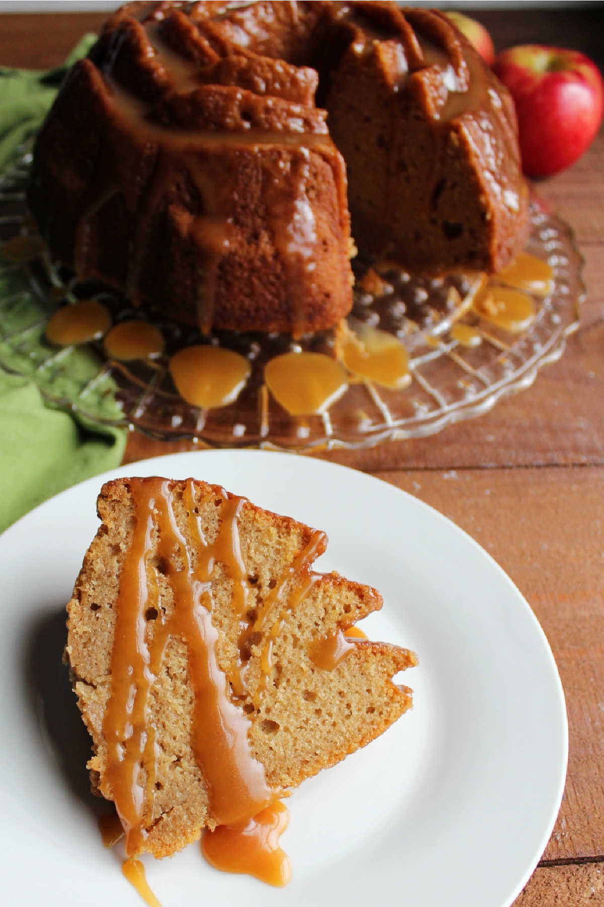 Slice of apple bundt cake served with a drizzle of extra caramel sauce.