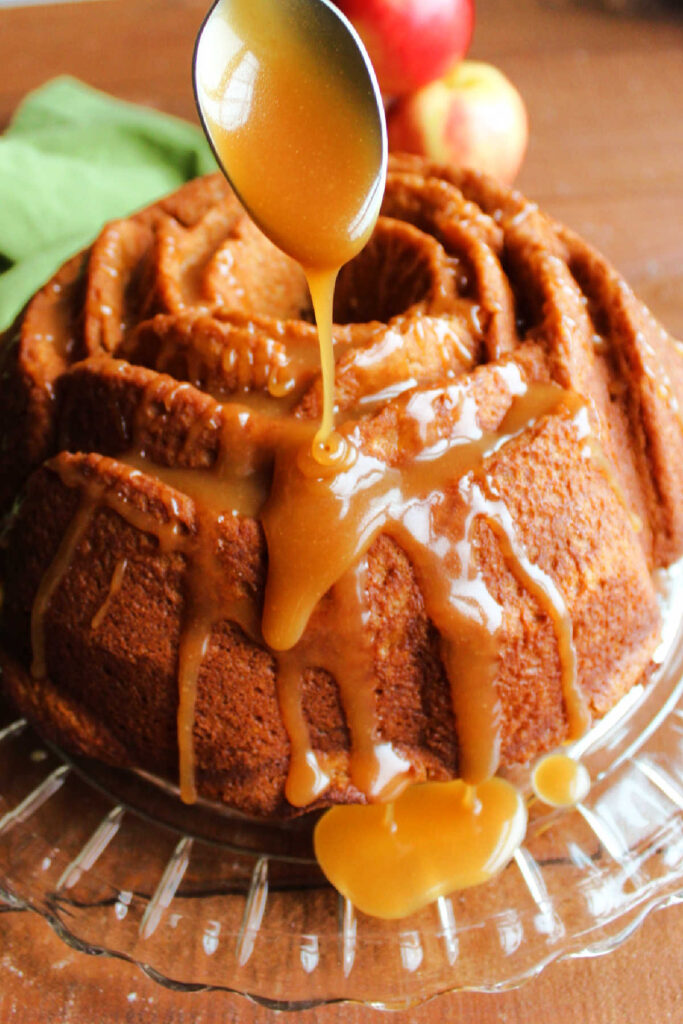Apple Cider Bundt Cake 7 Spooning apple cider caramel sauce over bundt cake.