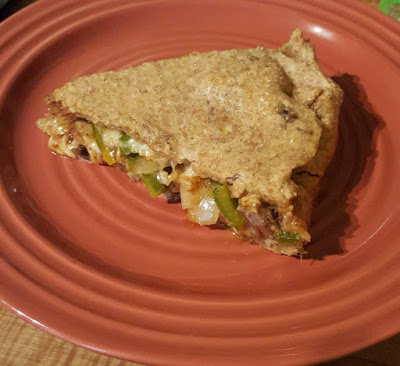 Slice of giant stuffed pizza with whole wheat sourdough crust on top and bottom of toppings. 