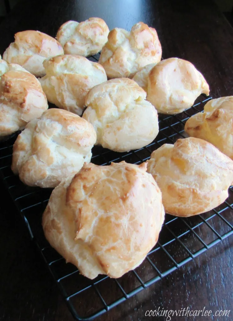 Large choux puffs on cooling rack.