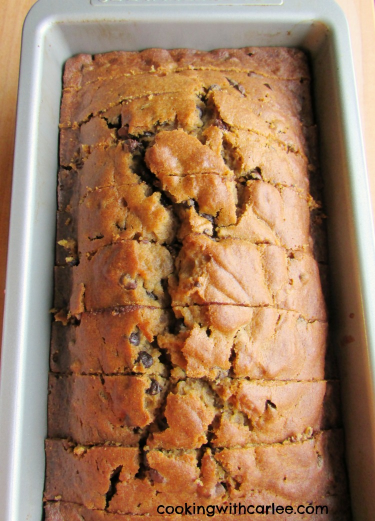 loaf pan filled with slices of pumpkin chocolate chip quick bread.