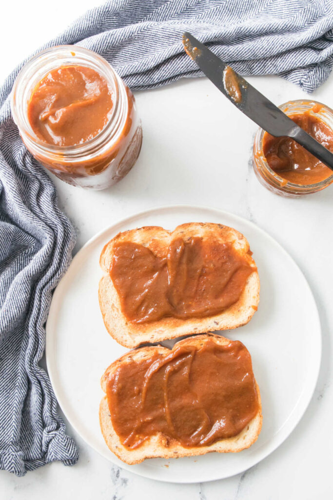 Two pieces of toast topped with homemade pumpkin butter.