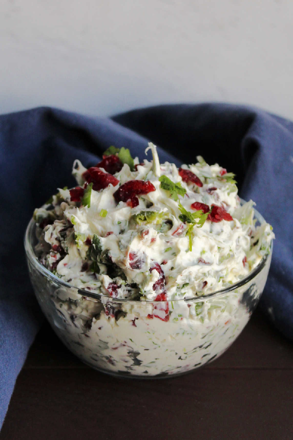Small glass bowl filled with cranberry jalapeno cracker spread.
