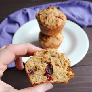 hand holding half of a cranberry oatmeal sourdough muffin