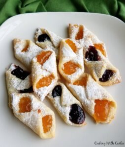 plate of kolacky, some with apricot filling and some with berry filling.