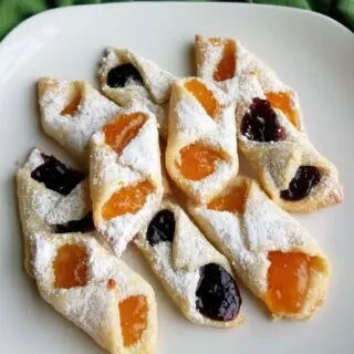 plate of kolacky, some with apricot filling and some with berry filling.