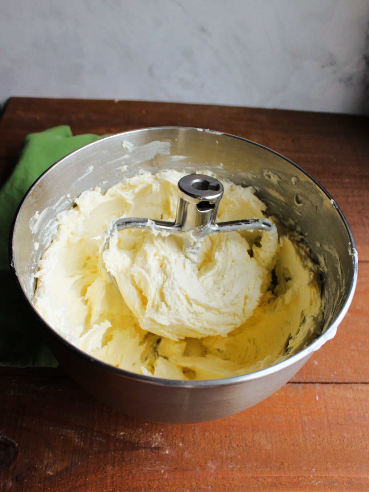 Mixer bowl with whipped butter and cream cheese inside.