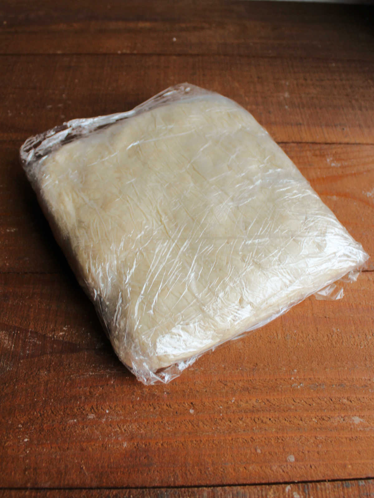 Kolacky dough wrapped in plastic wrap chilled and ready to be rolled out.
