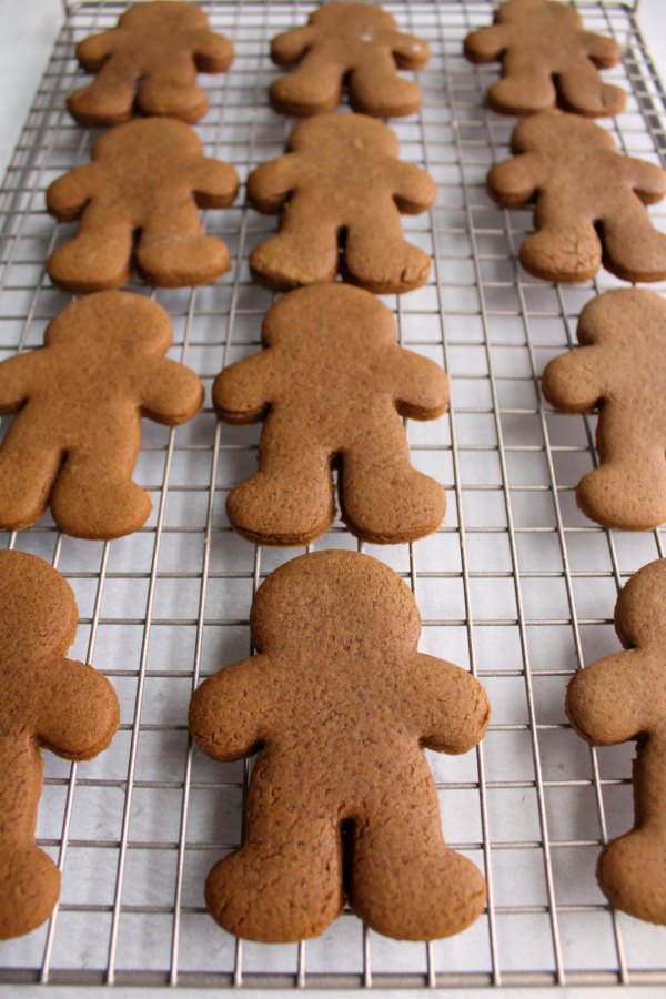 gingerbread man cookies cooling on wire rack.